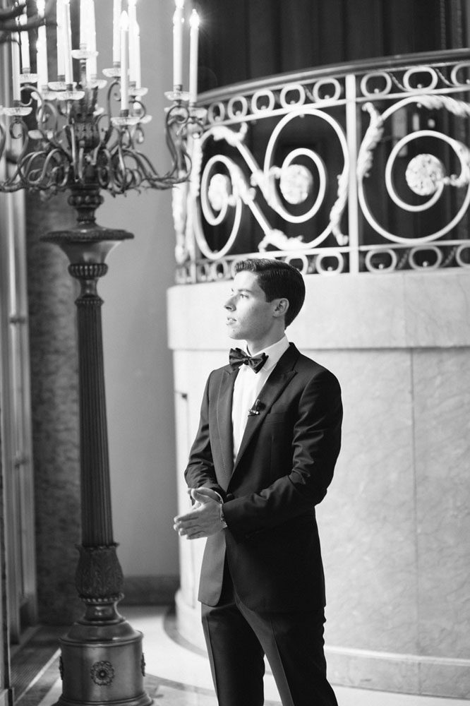 The groom stands alone waiting for his bride