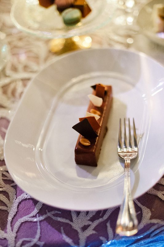 A piece of the wedding cake served on a plate