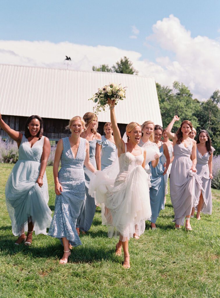 The bride is posing with all her bridesmaids
