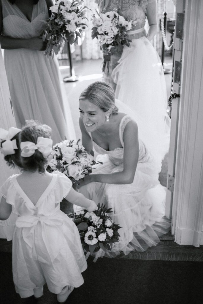 The bride is interacting with a cute little girl