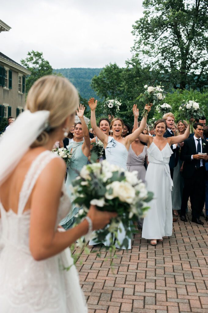 The bride is cheered by her friends on her wedding