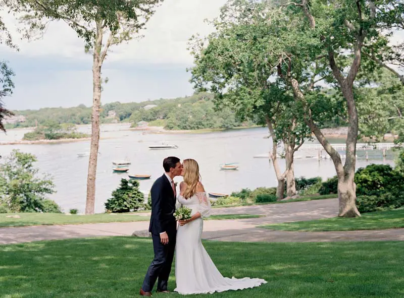 The bride and the groom kissing in scenic surroundings