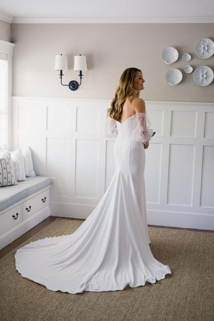 The bride wearing her flowing white bridal dress