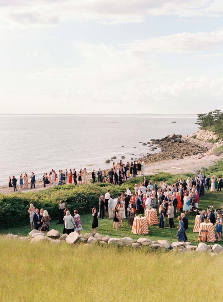 Guests walk in the beach close to the wedding venue