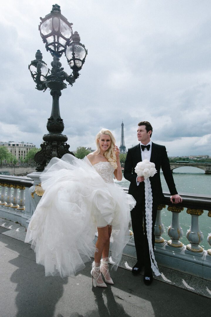 The bride and the groom walking across a bridge
