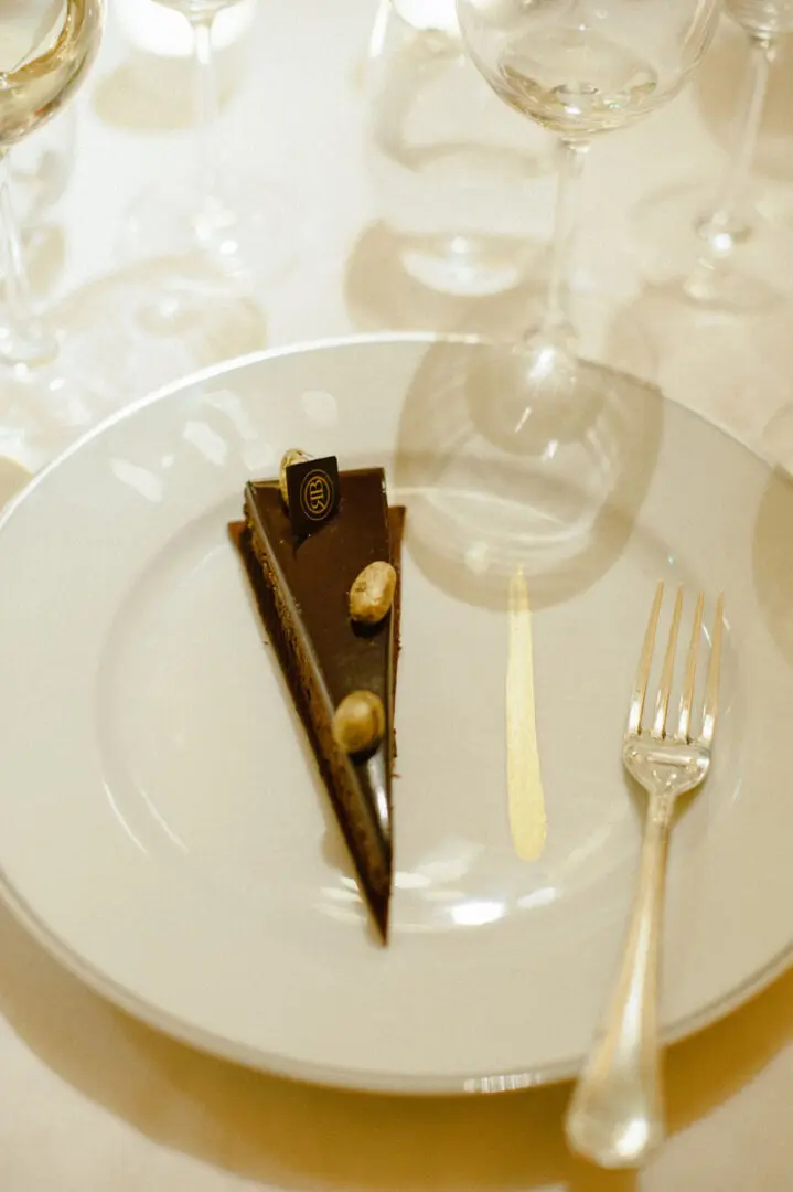 A piece of cake is placed on beautiful cutlery