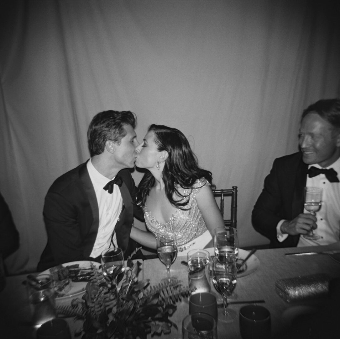 The bride and the groom kissing during the banquet