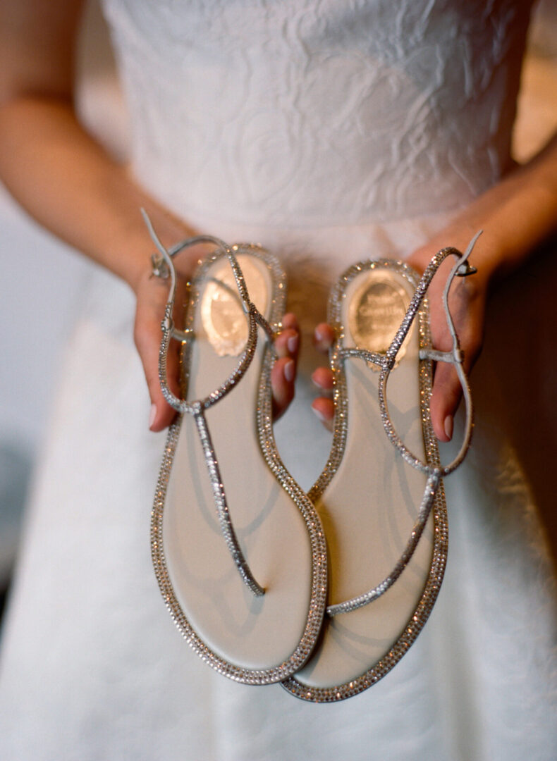 The bride examines the bridal slippers that she will wear