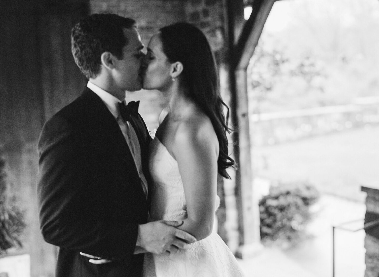 The bride and the groom enjoy a passionate kiss