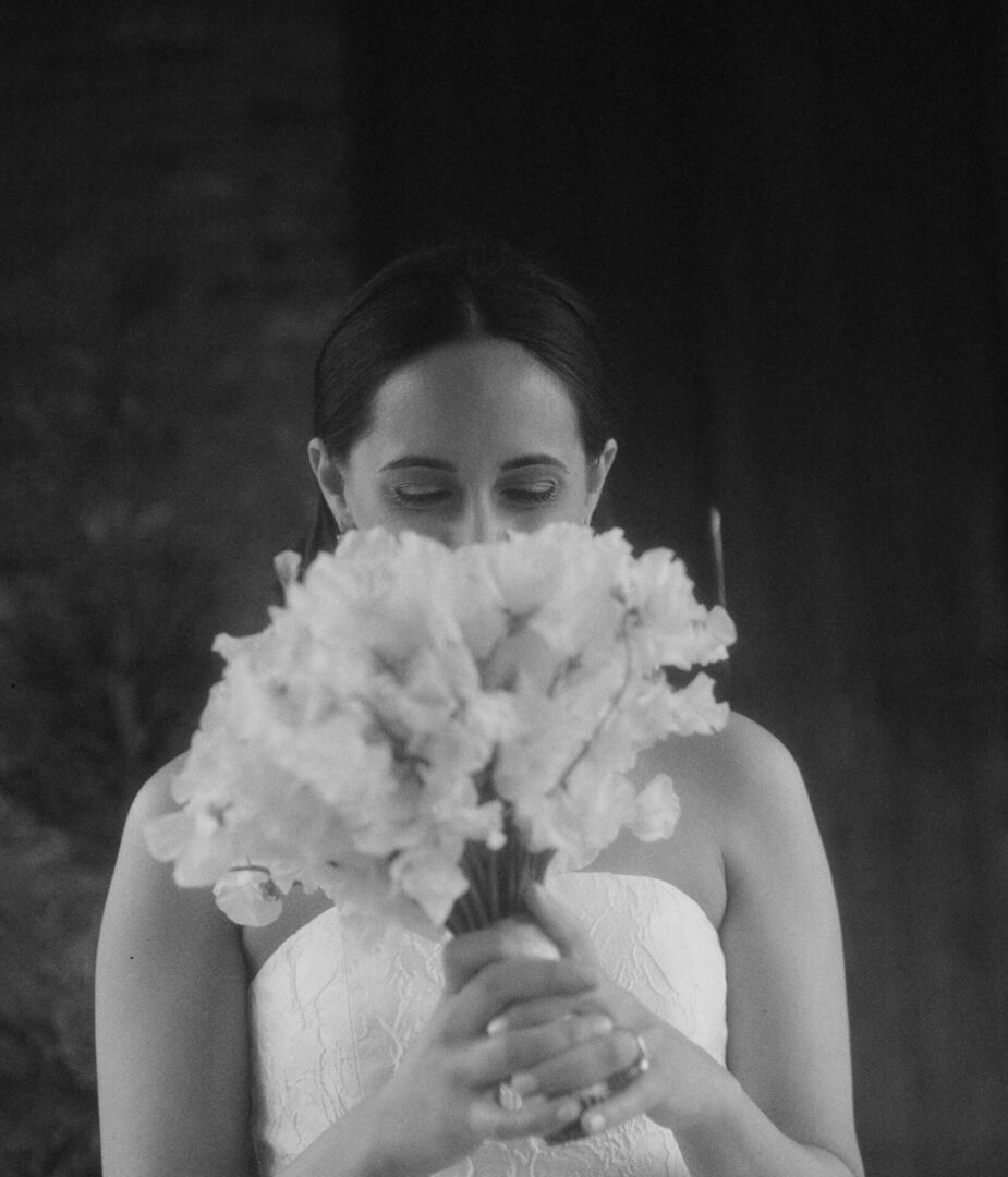 The bride examines the beautiful bouquet of flowers