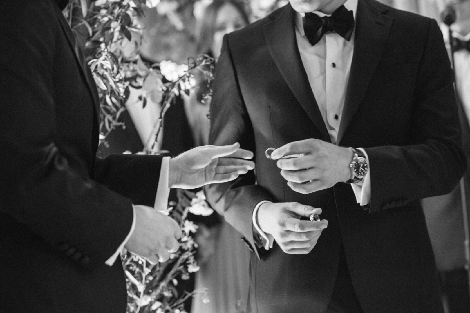 The groom receives the wedding ring from the best man