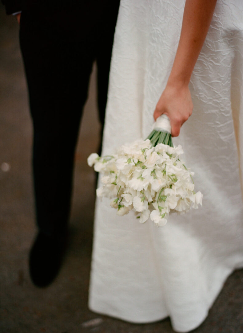 The bride holds on to her wedding bouquet