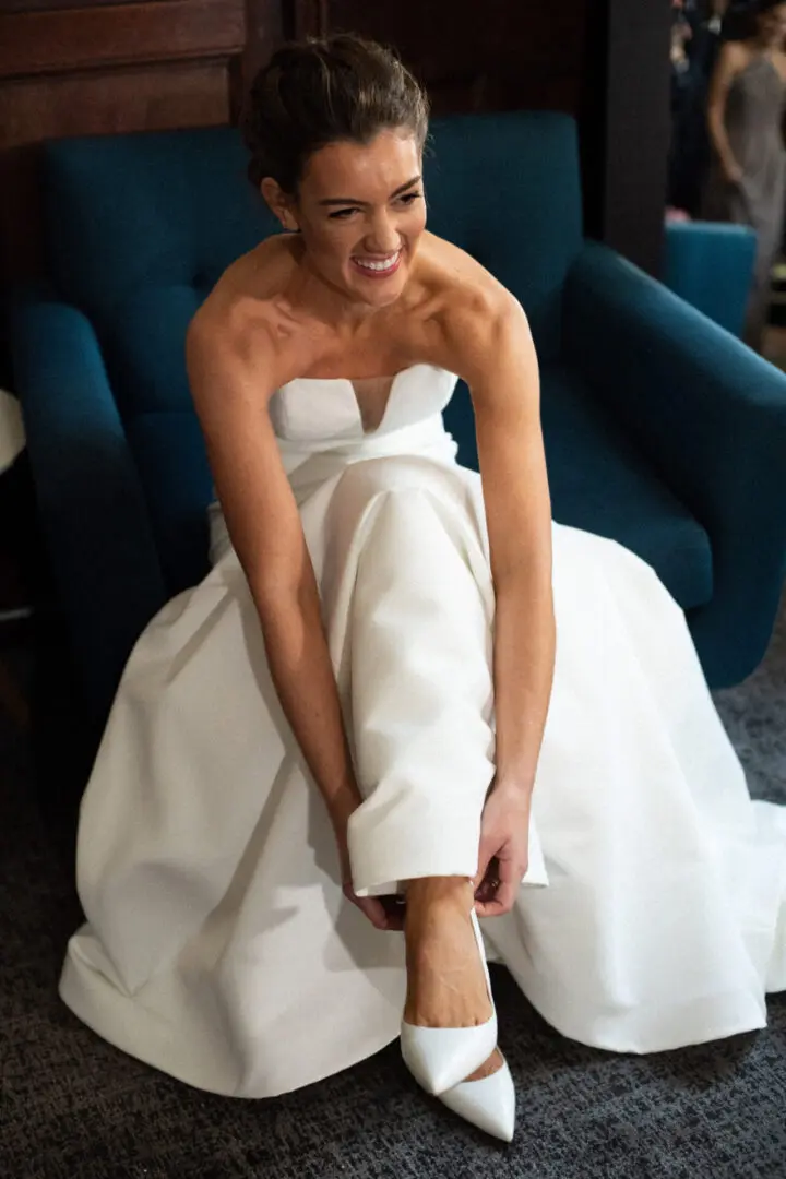 The bride fits herself into the shoe designed for the wedding