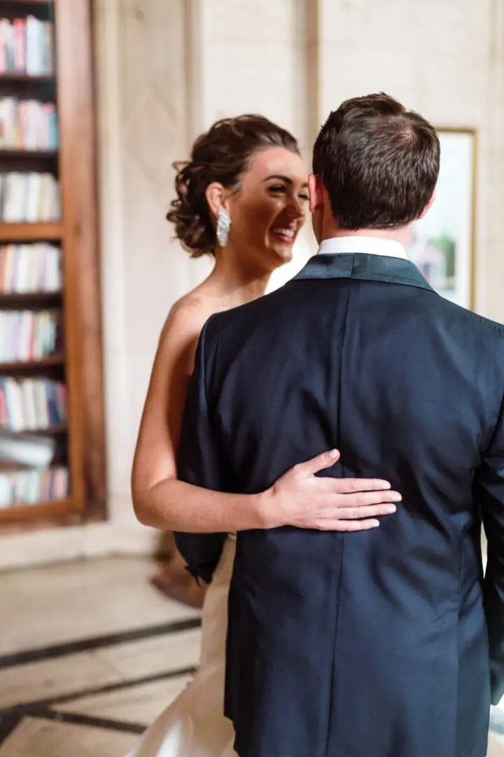 A picture of a bride smiling with groom