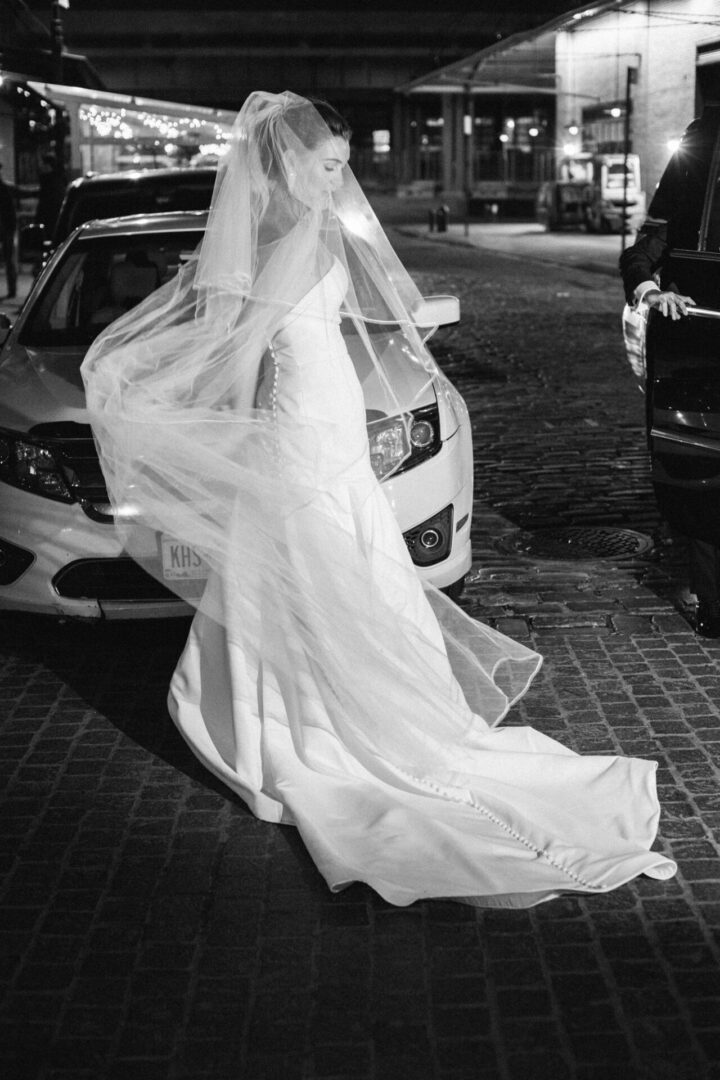 The bride steps out of the car for the reception party