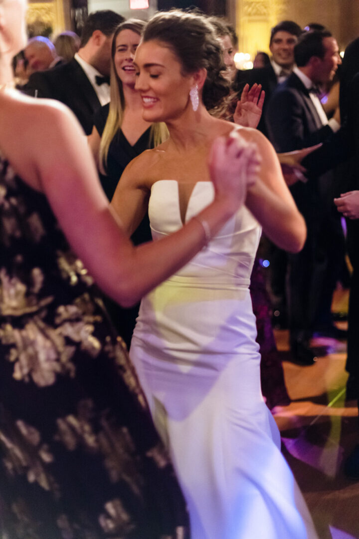 The bride is dancing with her friends at the ceremony