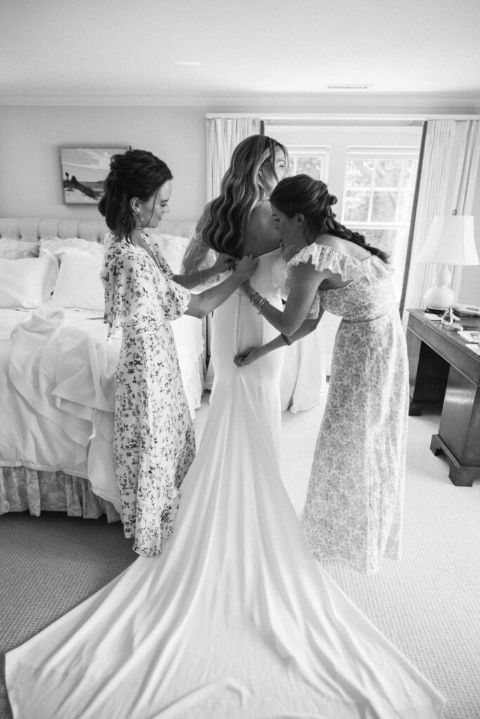 A picture of a bride getting her dress checked