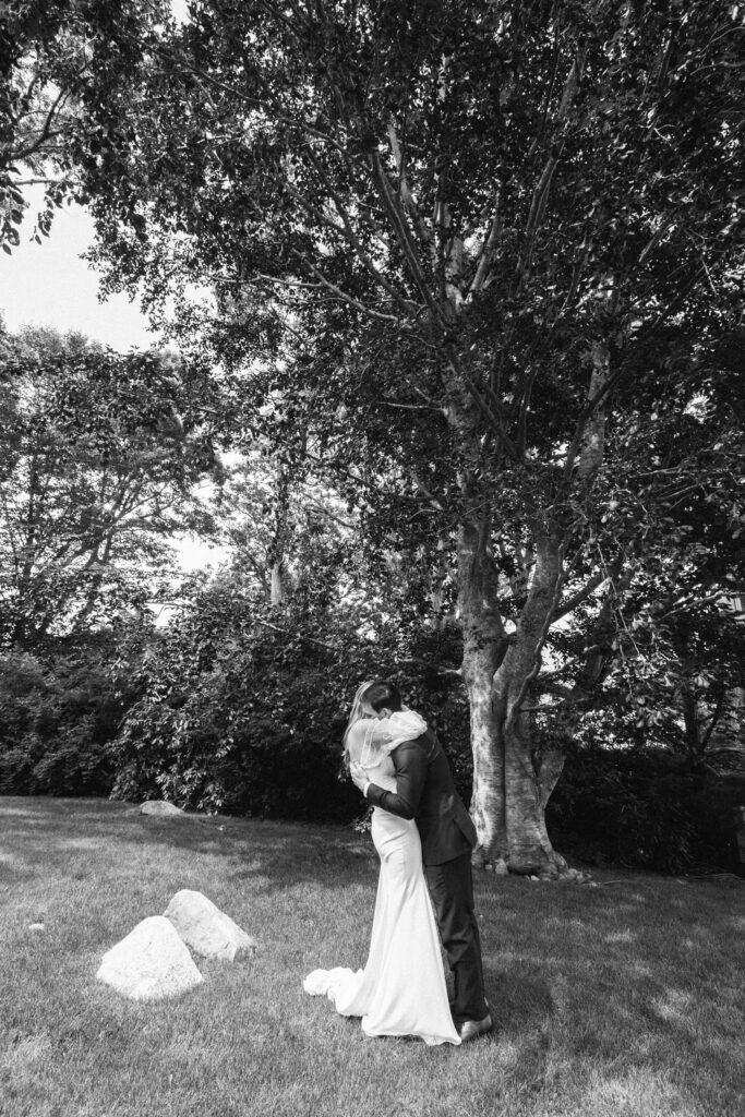 The bride and the groom kissing in the park