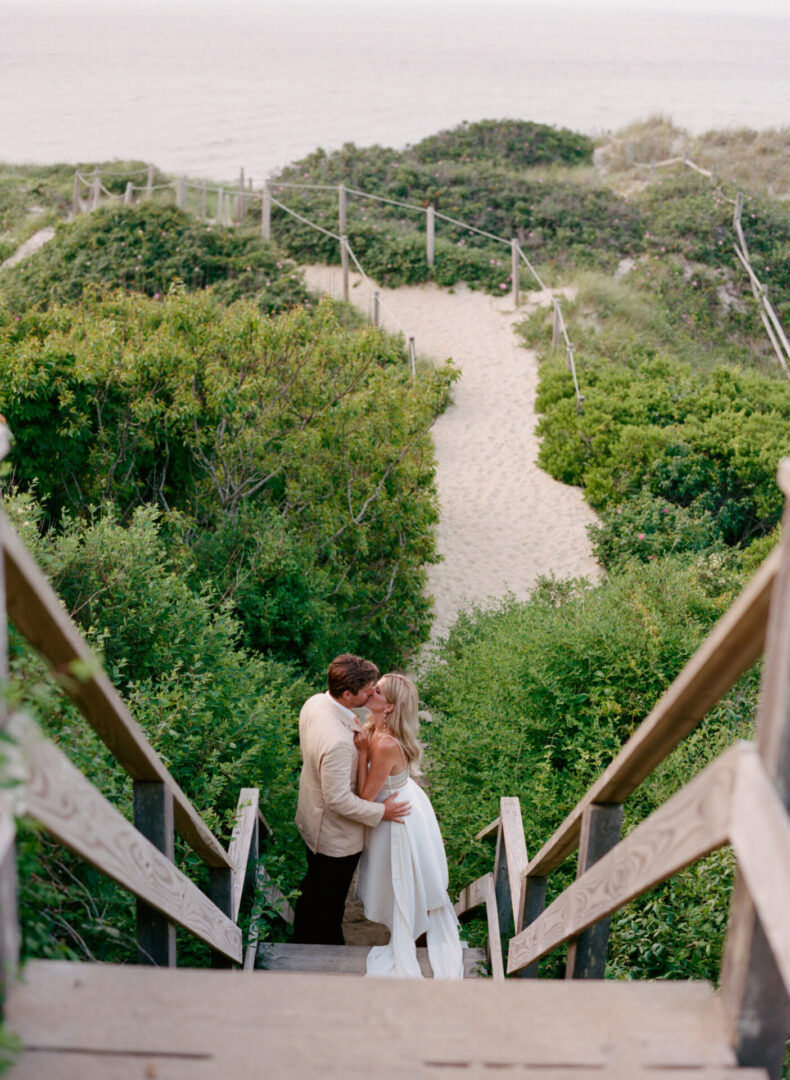 The bride and the groom kissing amidst lovely surroundings