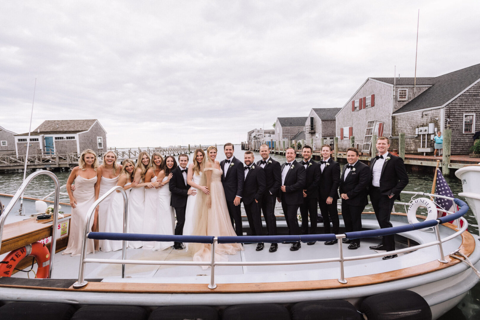 Guests are posing on a beautiful boat with the couple