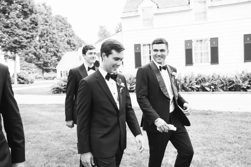 The groom enters the venue with his best friends