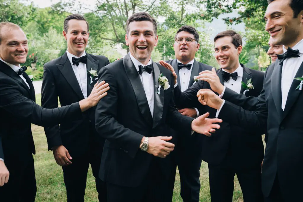 The groom receives cheer and encouragement from friends