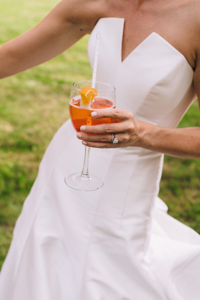 The bride holds on to a glass of juice after the ceremony