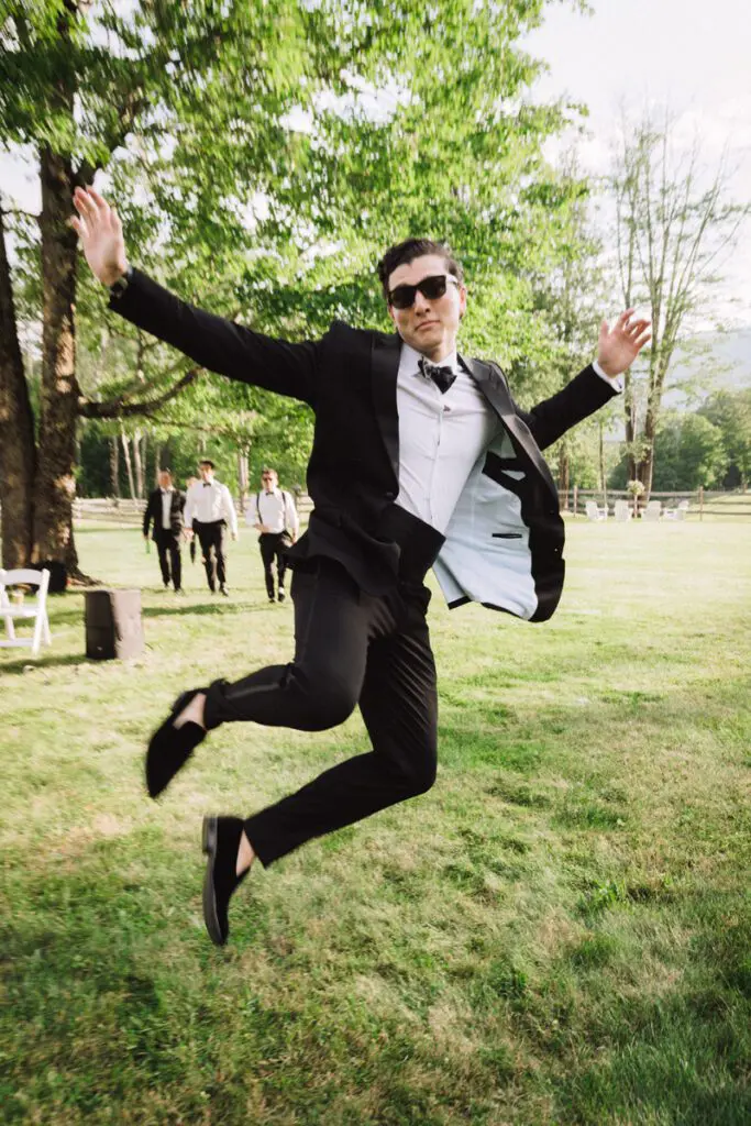 A friend of the groom jumping in the air with joy