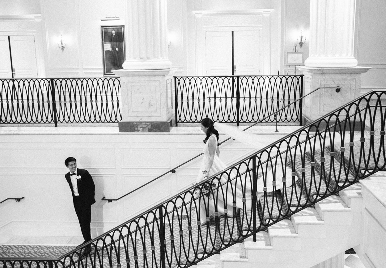 Newlywed couple standing at the stairs