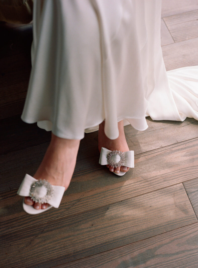 Wedding sandals with wedding dress and brides leg