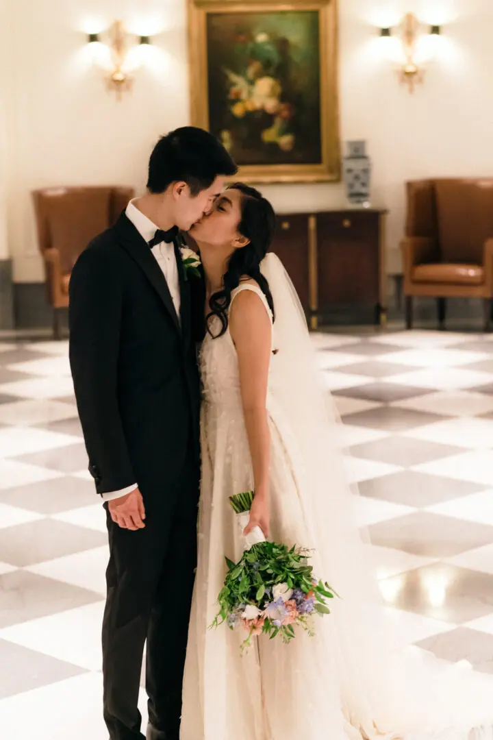Newlywed couple kissing at the hall