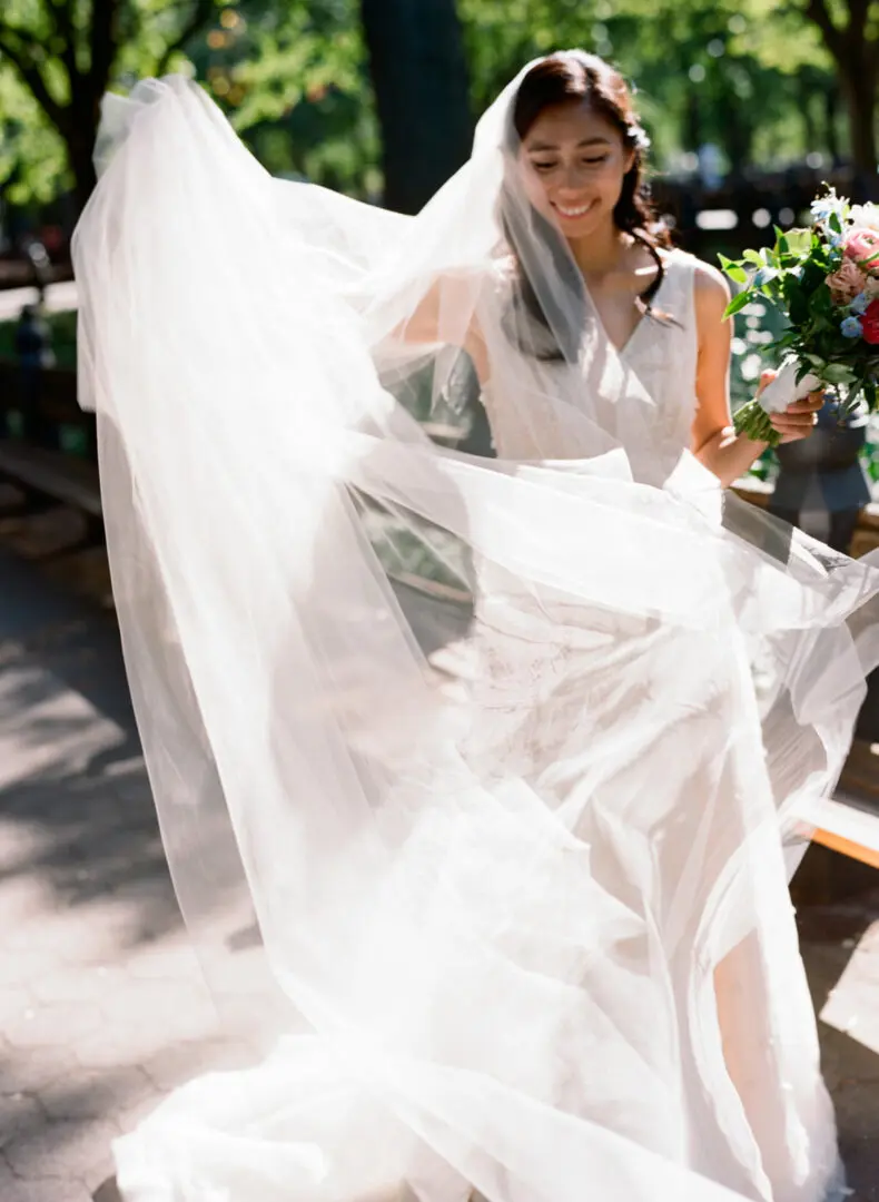 The bride arranges her dress on her wedding