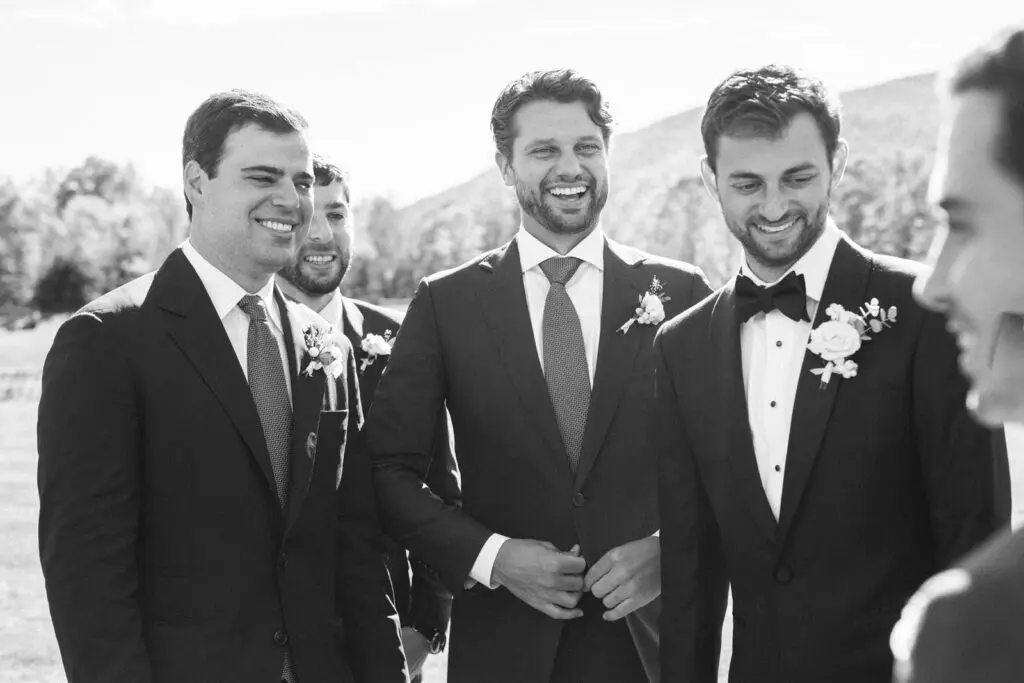 Groom standing and smiling with his friend
