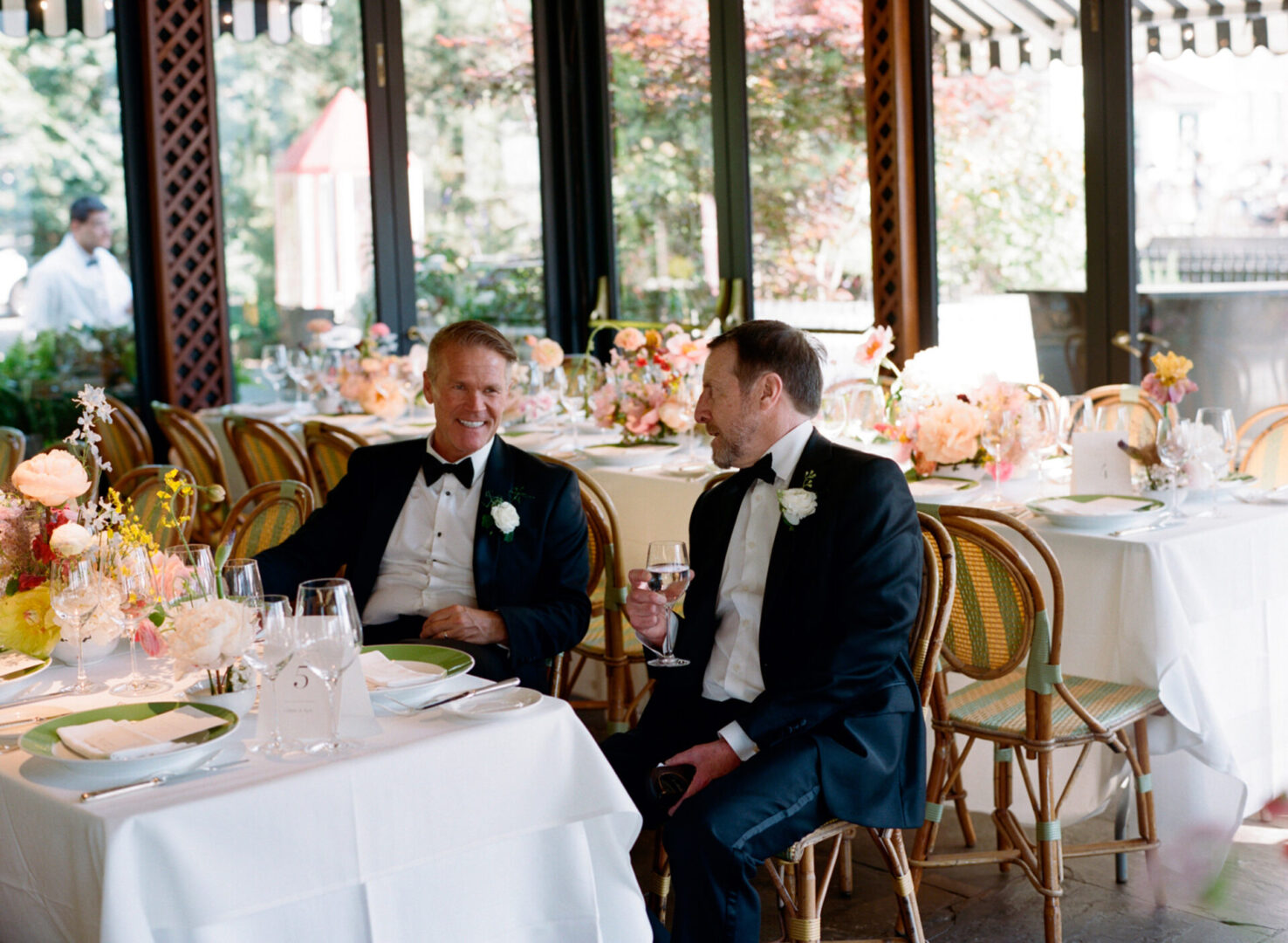 Two wedding guests sitting together at dining table