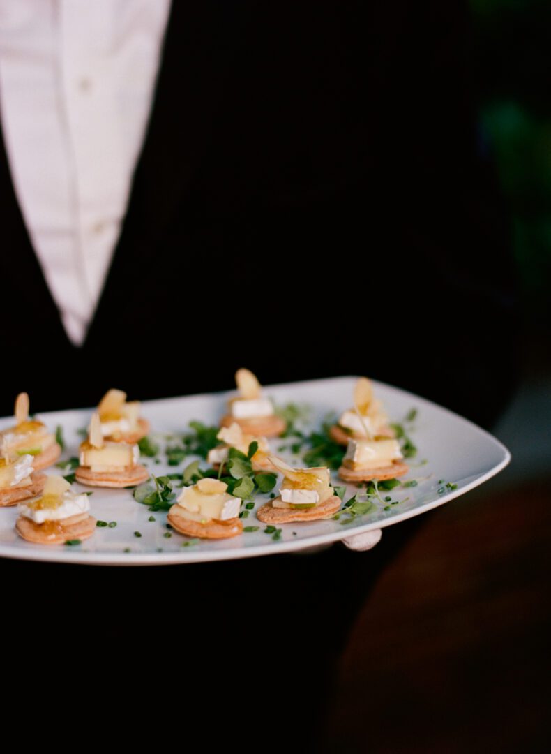 Waiter holding tray filled with food