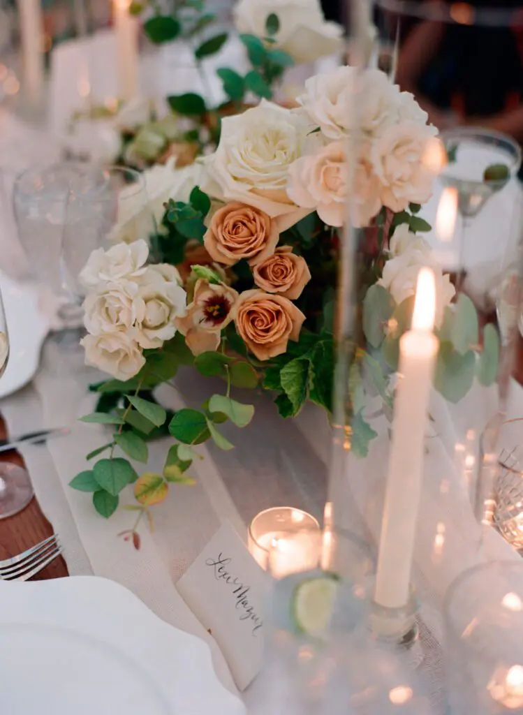 Flower vase arranged on wedding dining table with candles