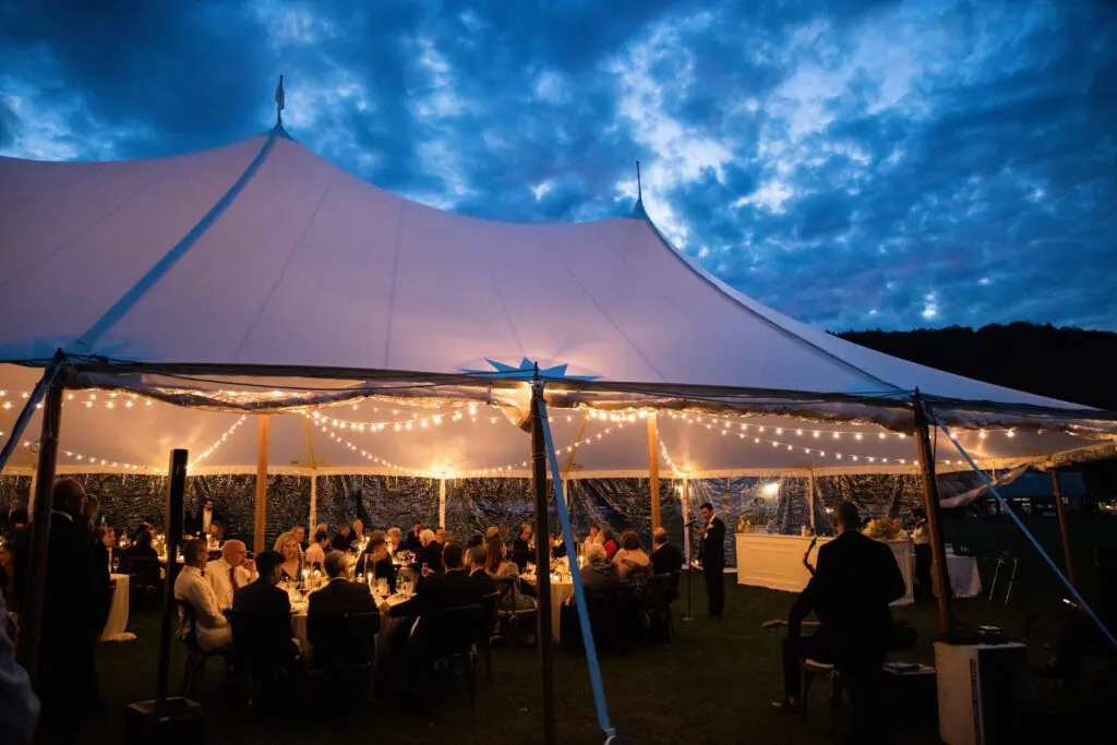 Group of people at the wedding event under a tent