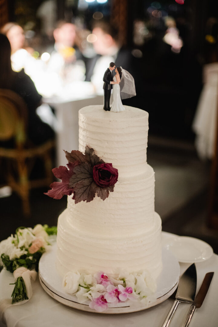 Beautiful white wedding cake with a couple at top