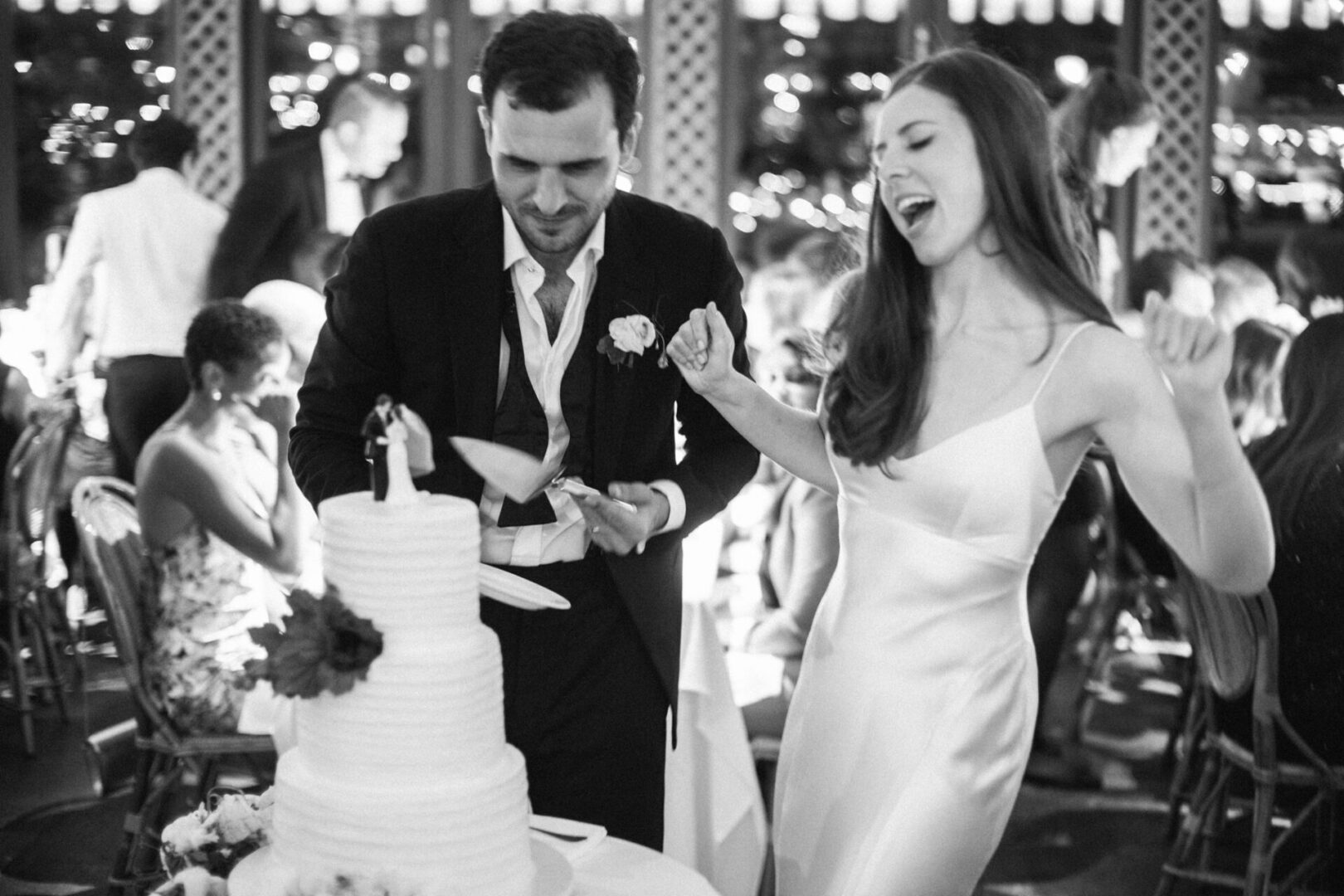 Couple dancing in front of cake