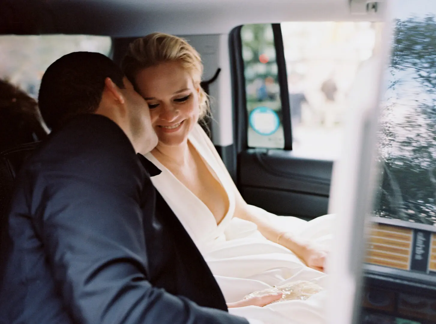 Groom kissing the bride inside the car