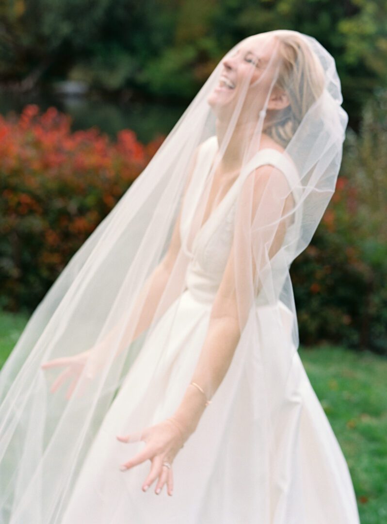 Bride in white gown laughing in happiness