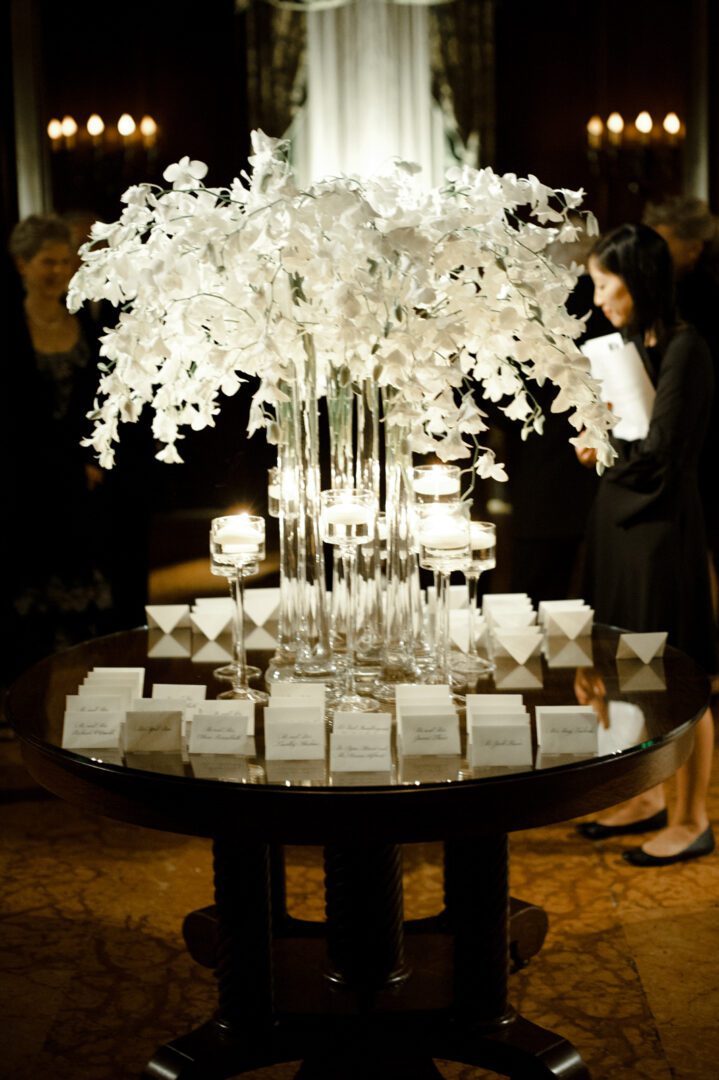 Round table with a glass flower vase with notes
