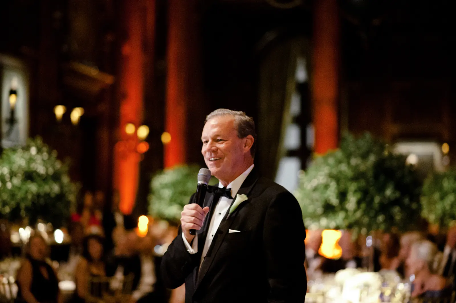 A man speaking in mike at the wedding event