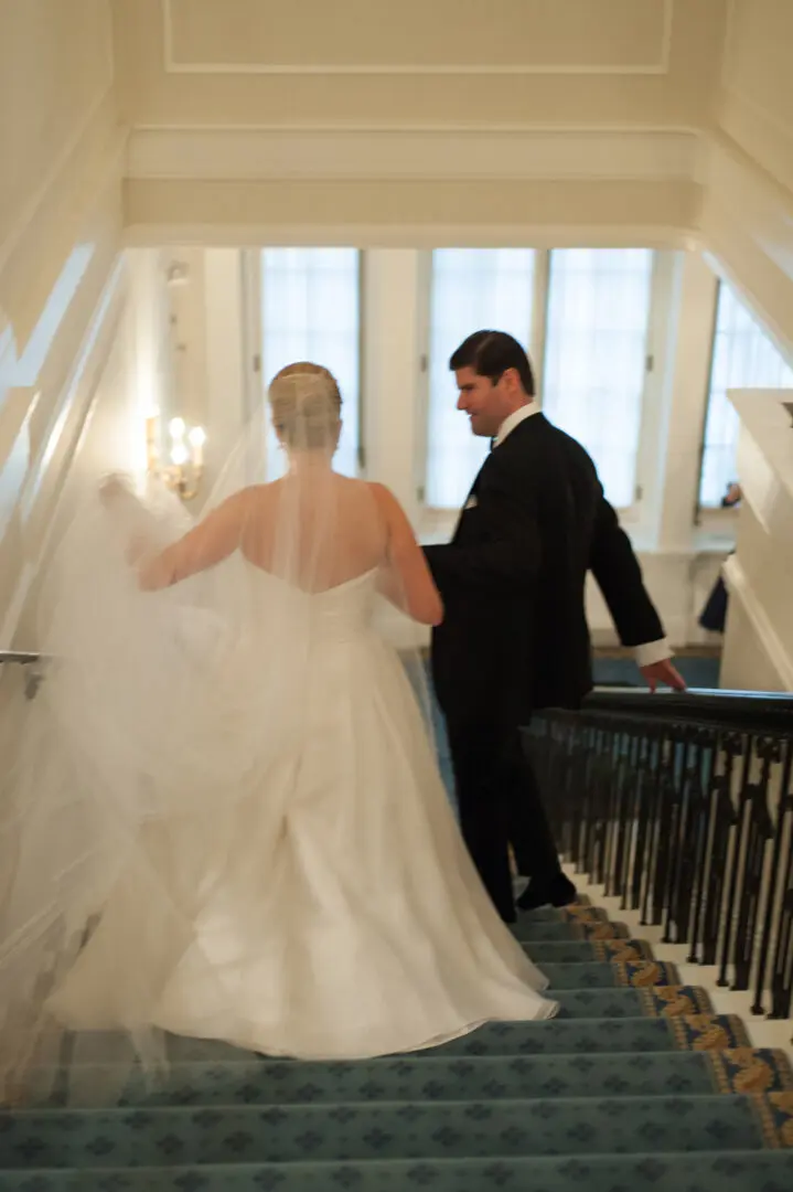 The bride and the groom walking on stairs