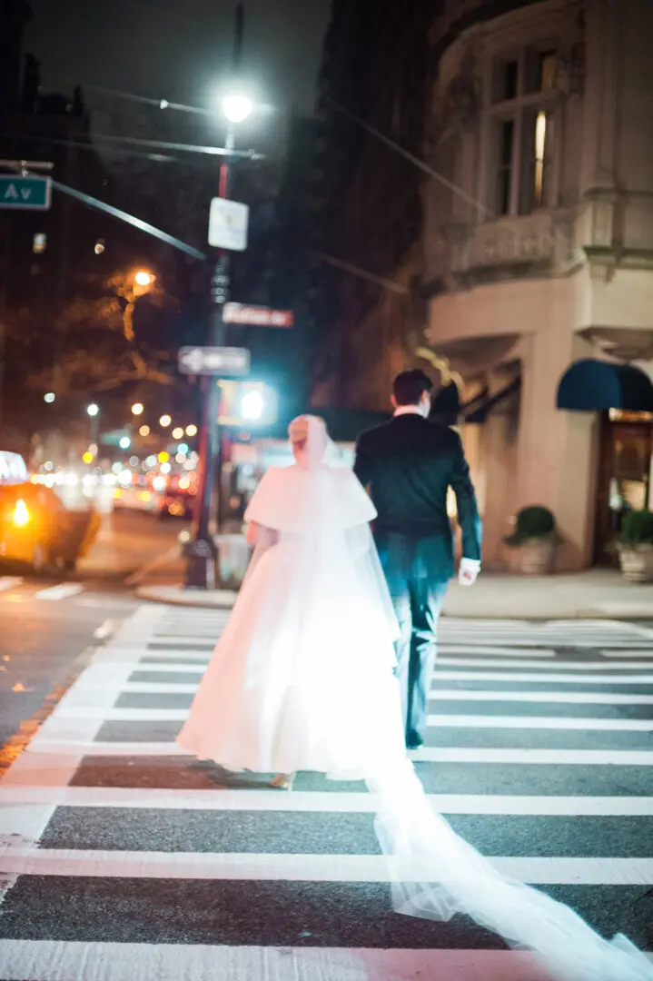 The bride and the groom crossing the street
