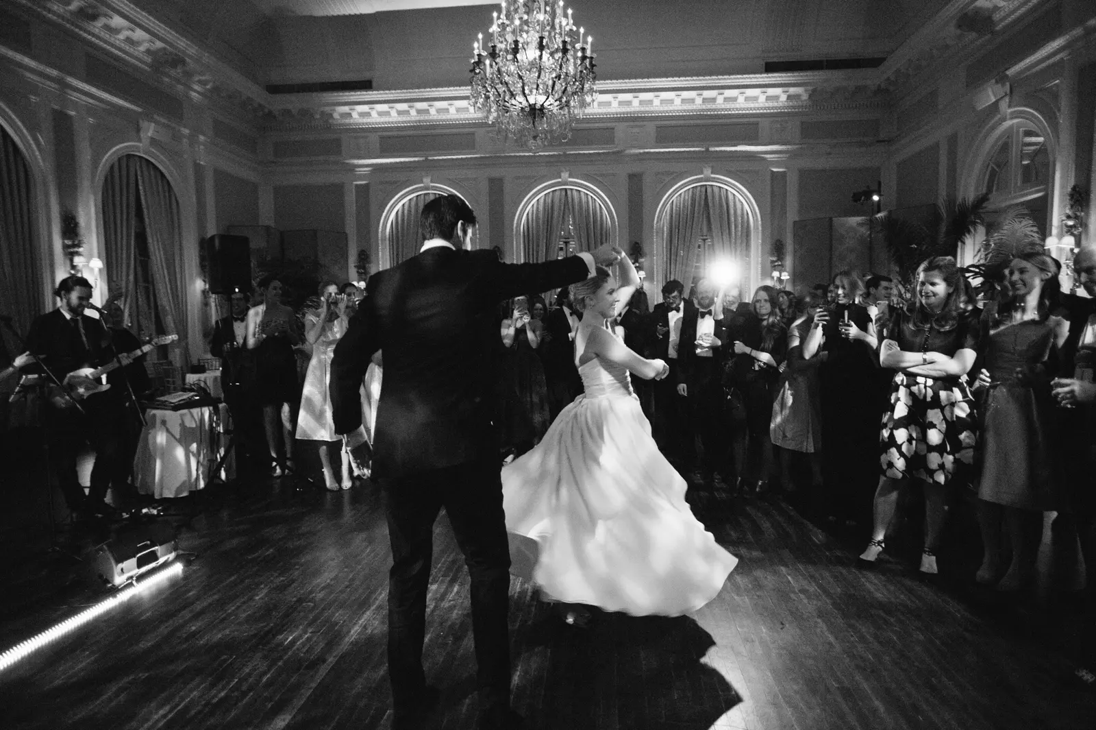 Black and white image of newly married couple dancing