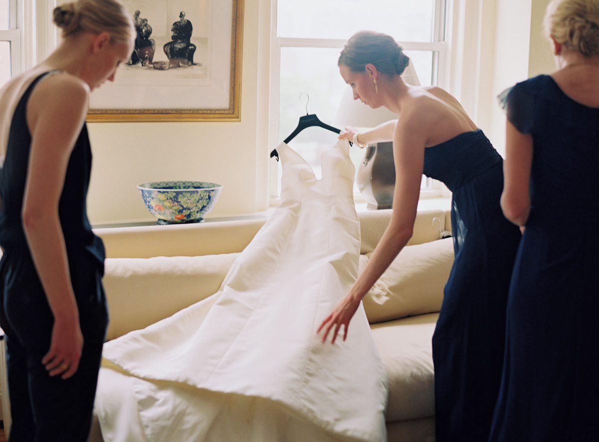 People arranging groom dress for wedding