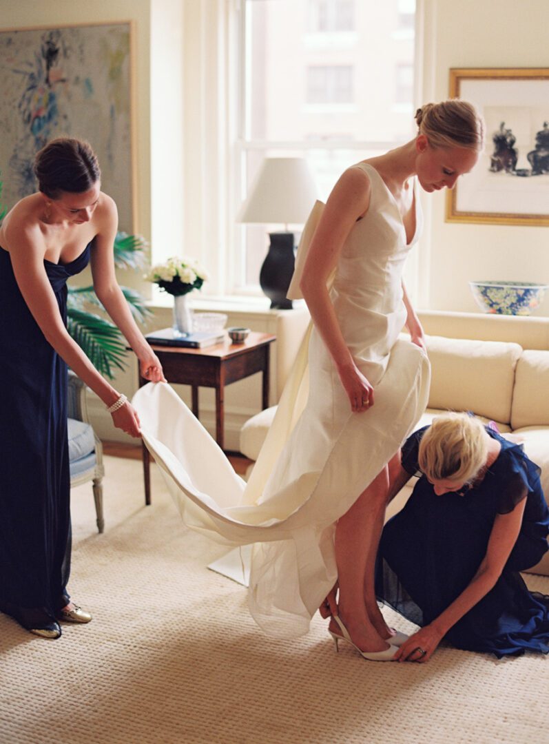 Girls arranging groom dress for wedding