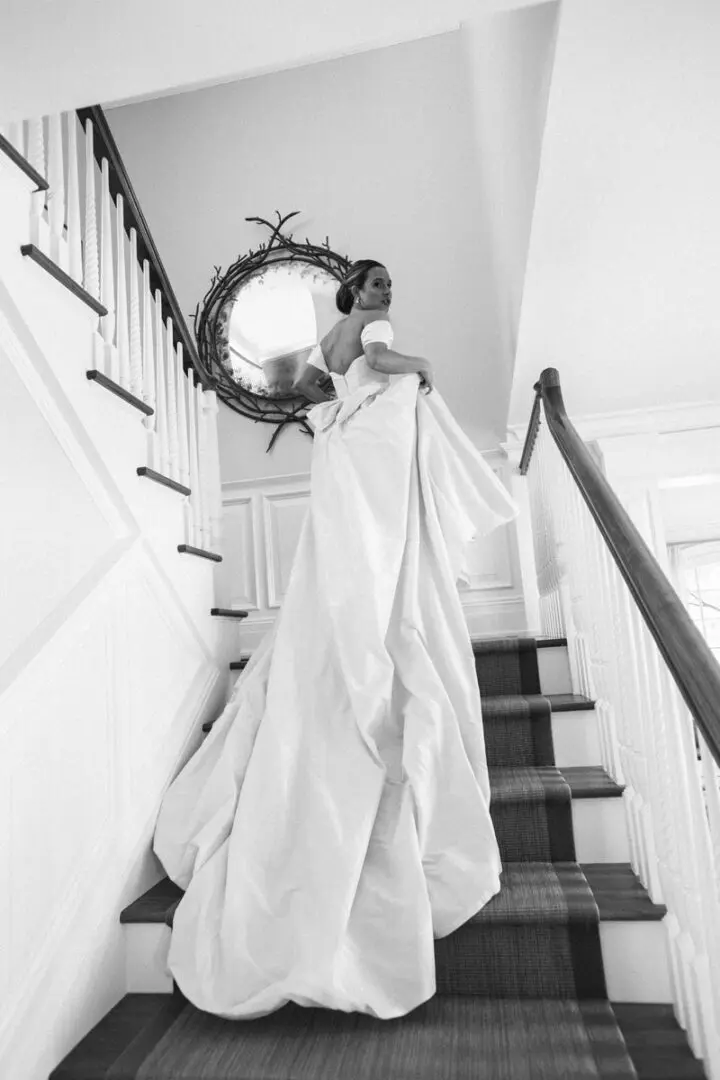 Black and white image of a bride on the stairs