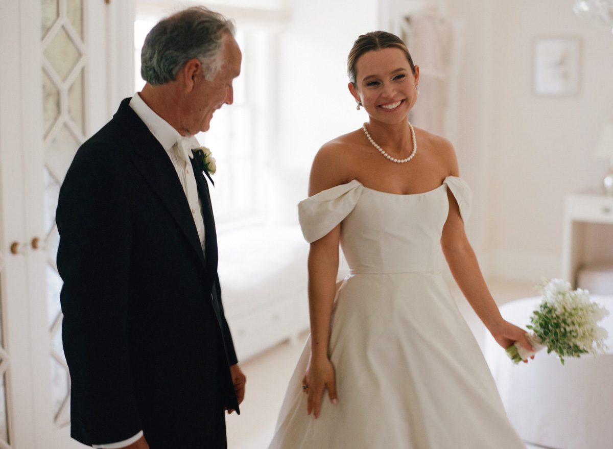 The bride smiling with her father